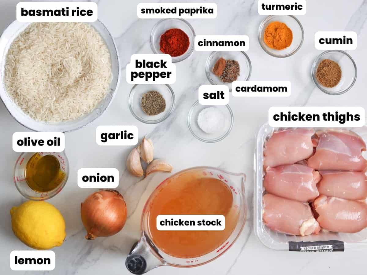 Ingredients for shawarma rice, including chicken thighs, basmati rice, lemon, and spices.