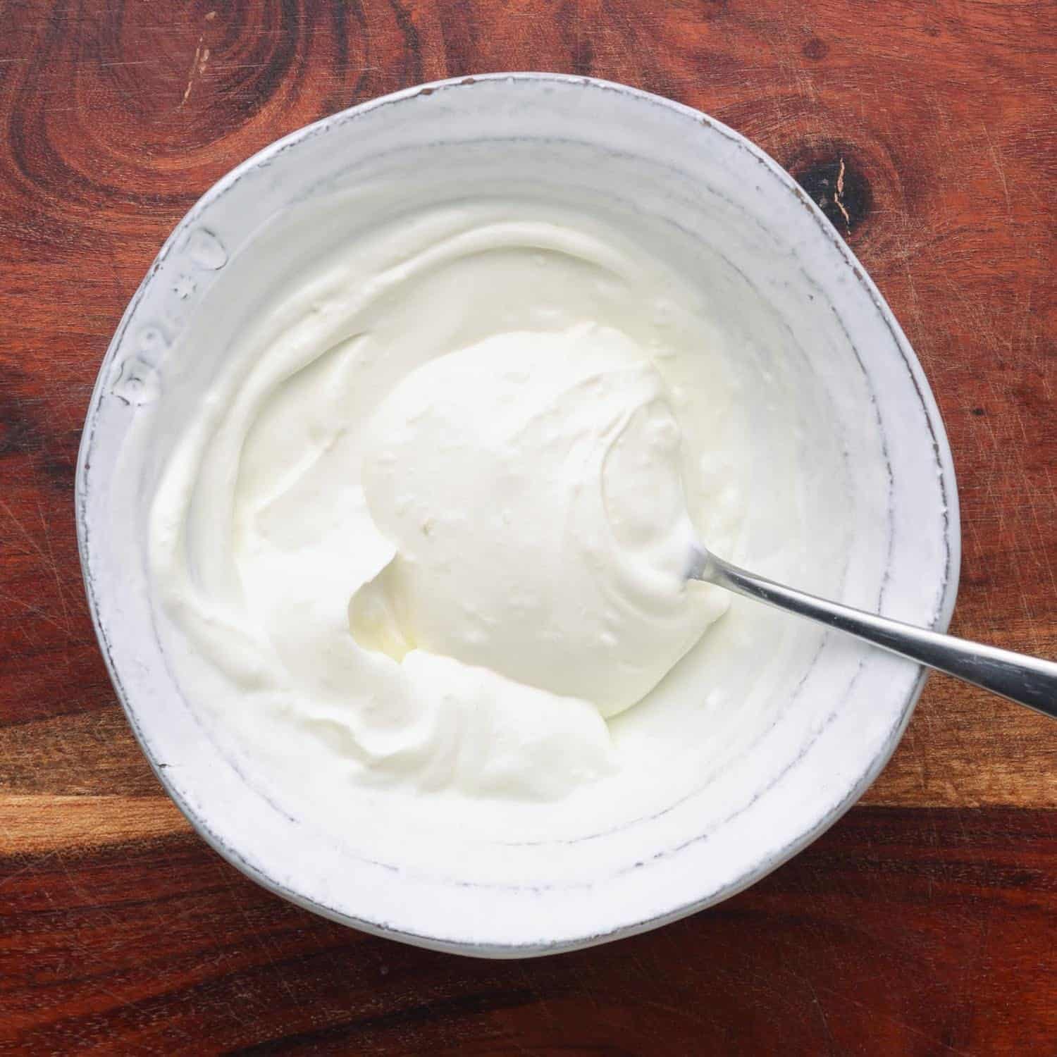 garlic yogurt sauce in a small white bowl. 