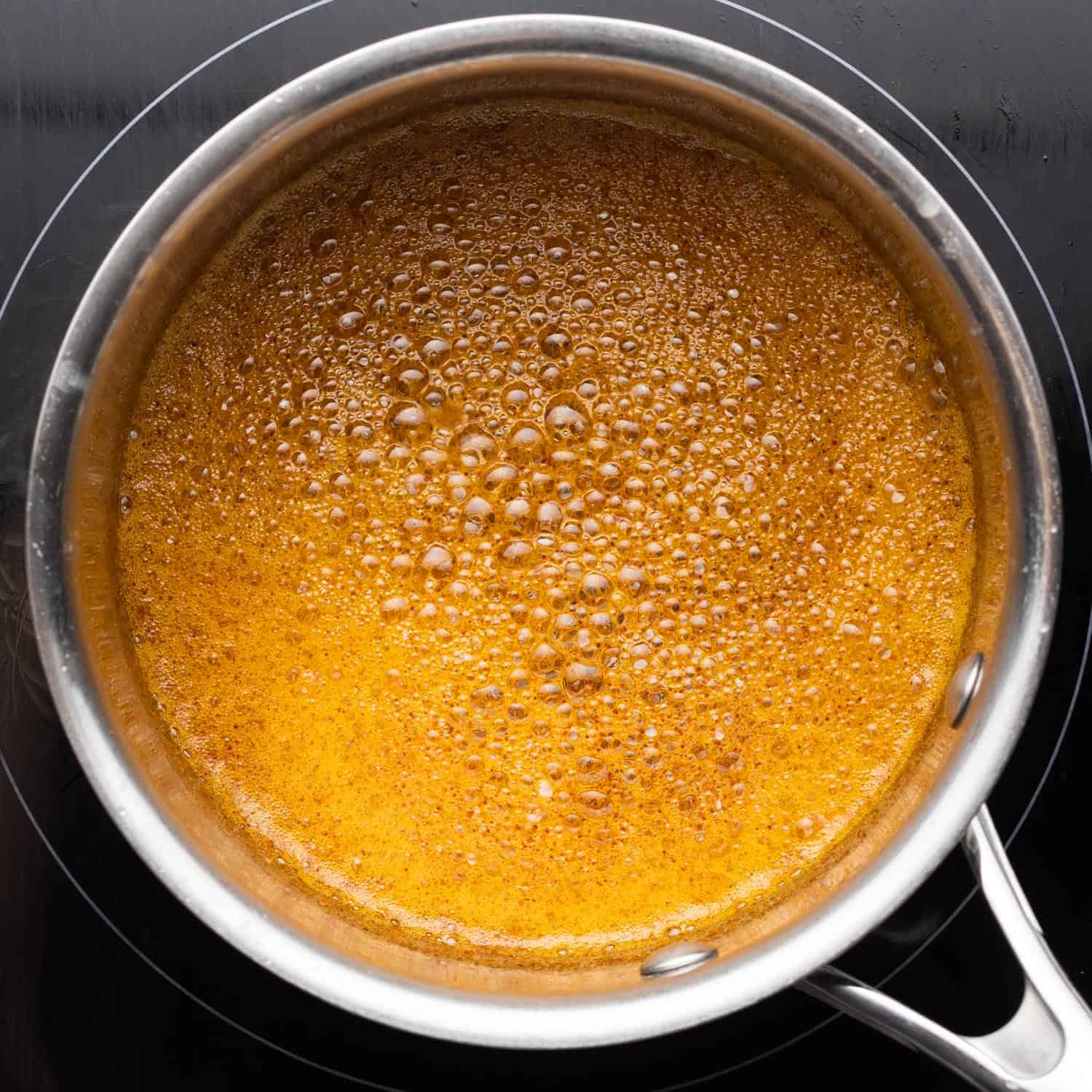 browned butter with paprika, cooking in a small saucepan.