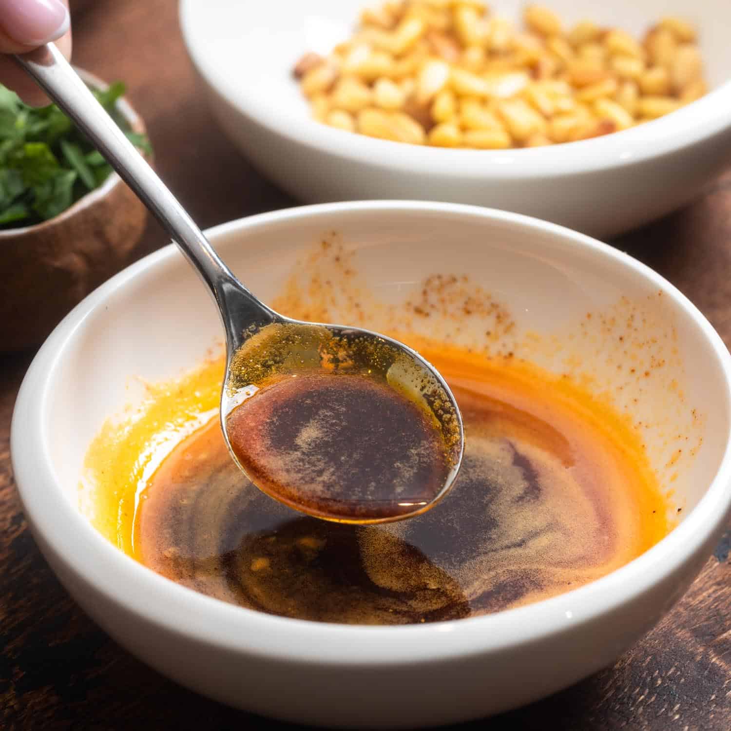 paprika browned butter in a small ceramic bowl with a metal spoon.