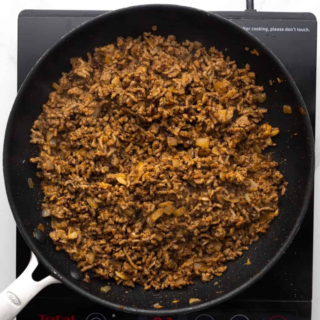 cooked ground beef for turkish pasta in a skillet.