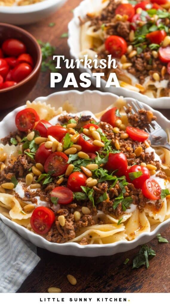 a white ceramic bowl of turkish pasta. Bow tie noodles topped with saucy ground beef, tomatoes, pine nuts, and fresh herbs. Text overlay says 