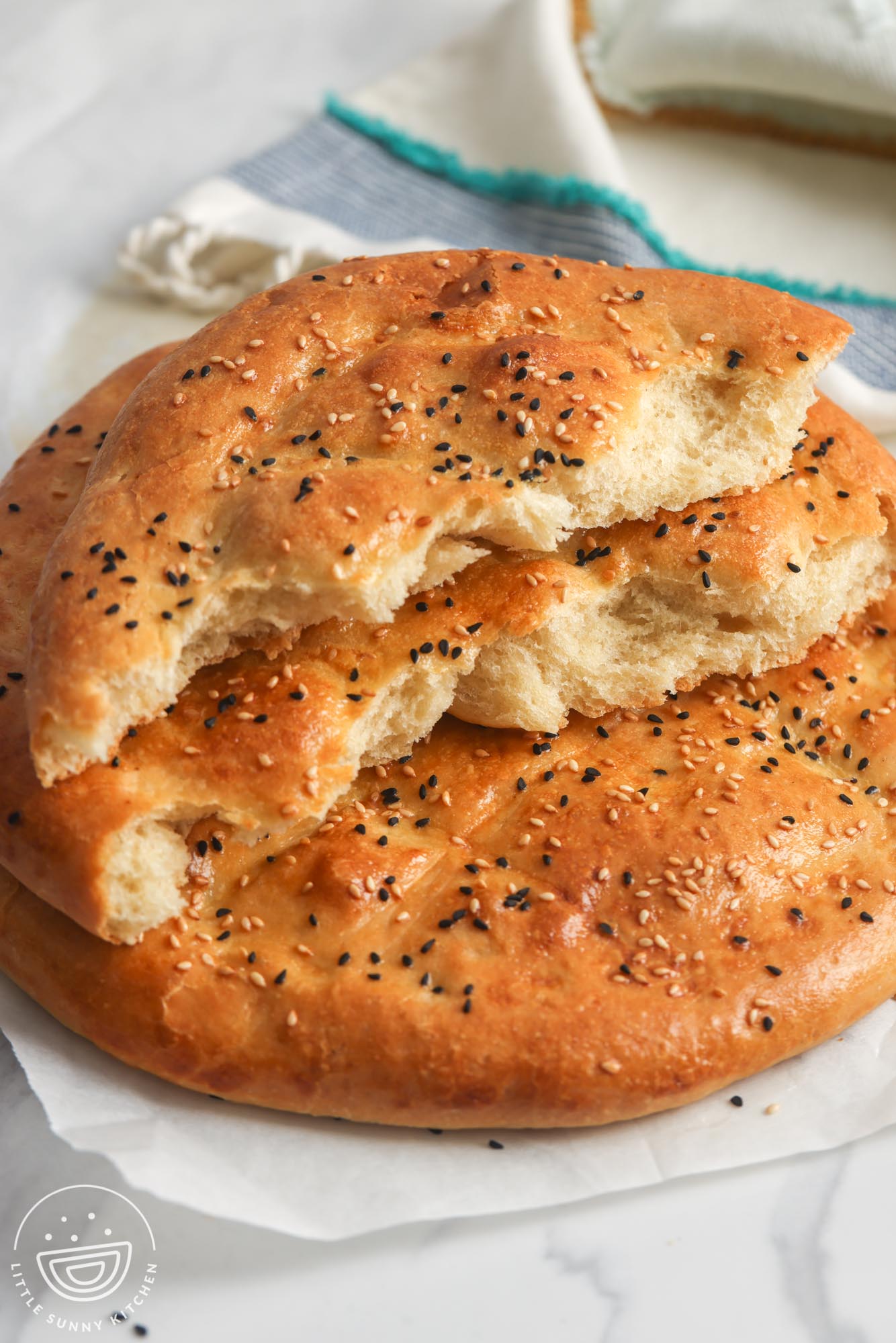 a loaf of ramadan bread torn in half to show the fluffy interior. 