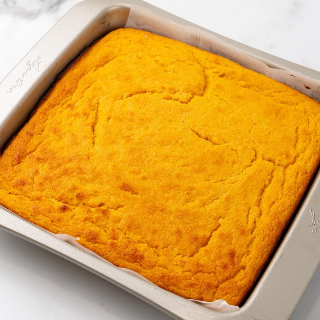 baked sweet potato cornbread in a metal square pan.