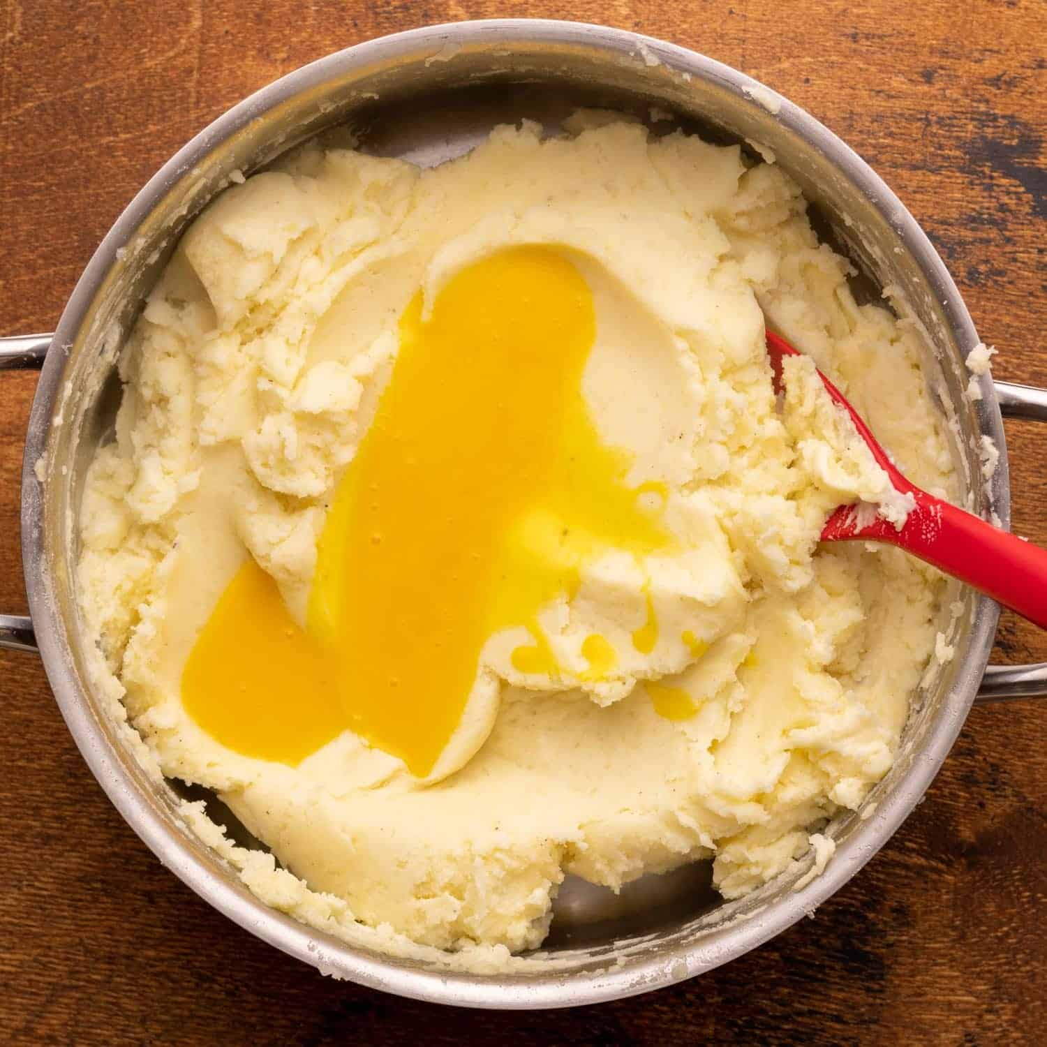 egg yolks added to a pot of mashed potatoes.