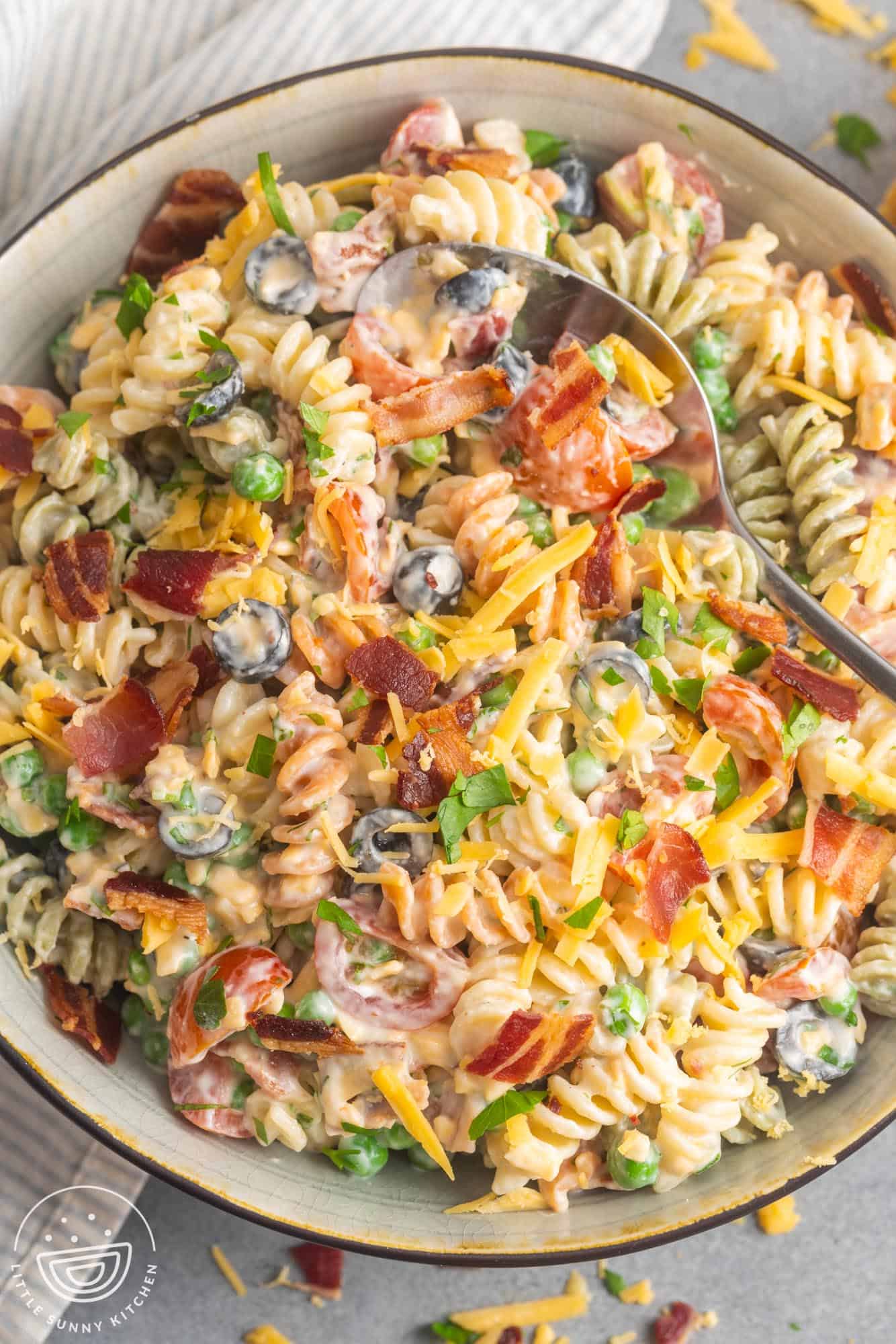 overhead view of a serving bowl filled with creamy bacon ranch pasta salad.