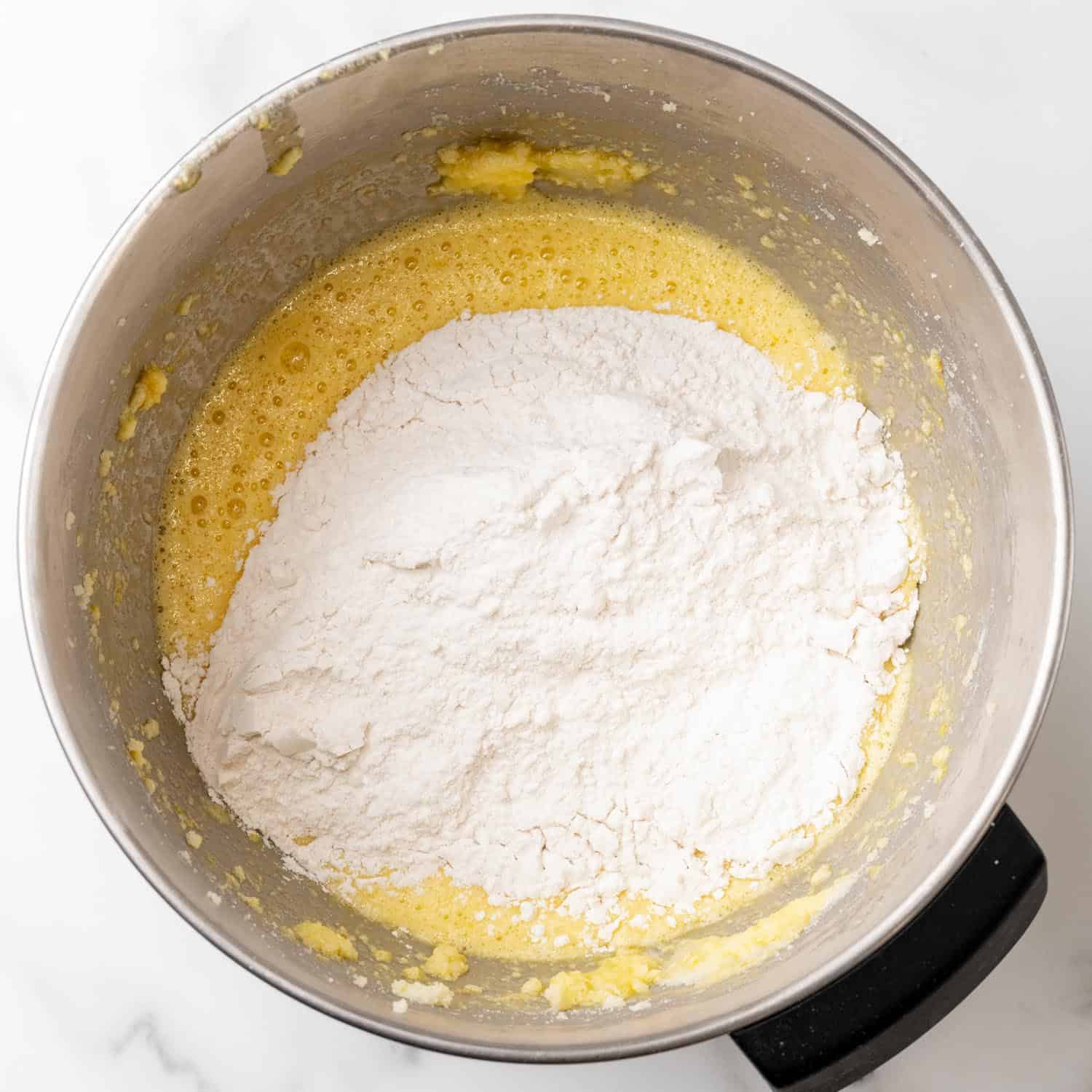 dry ingredients added to wet ingredients to make lemon loaf. 