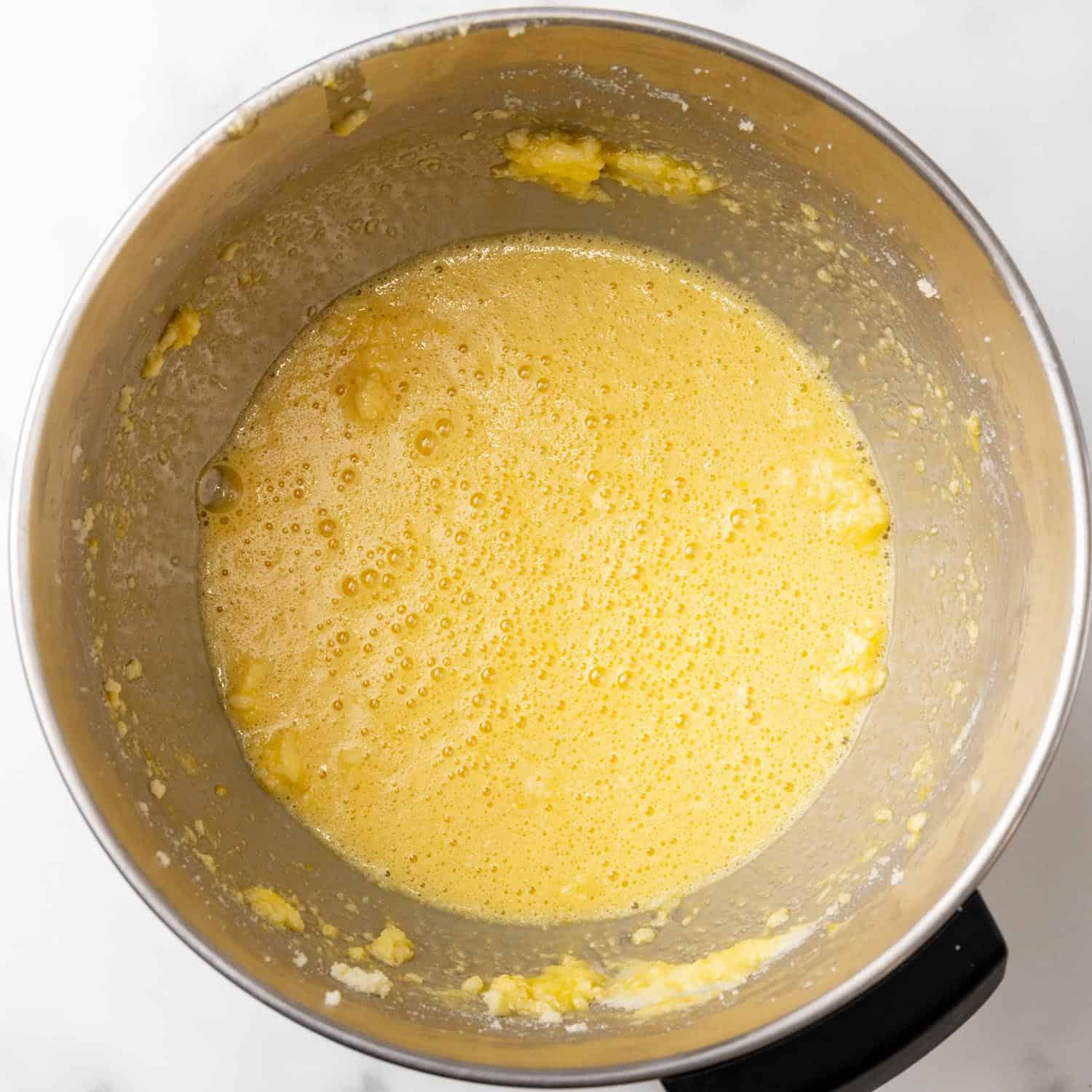 eggs, butter, sugar mixed in a stand mixer bowl. 