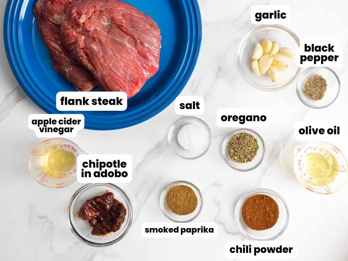 The ingredients for making flank steak like chipotle, including chipotle in adobo, chili powder, and garlic.