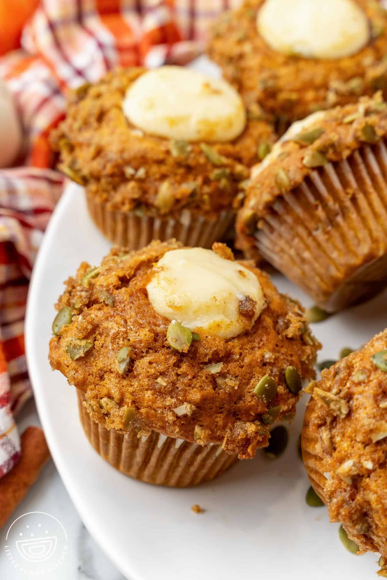 closeup of a homemade starbucks pumpkin cream cheese muffin on a platter.