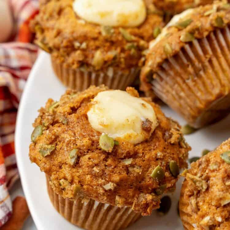 closeup of a homemade starbucks pumpkin cream cheese muffin on a platter.