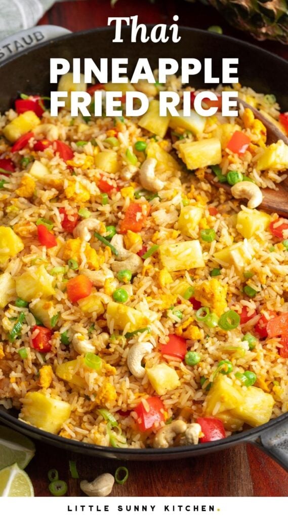 a skillet filled with fried rice with pineapple, peppers, and cashews. Text overlay says 